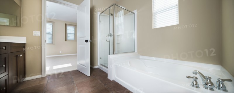 Contemporary bathroom with bath and glass shower at home
