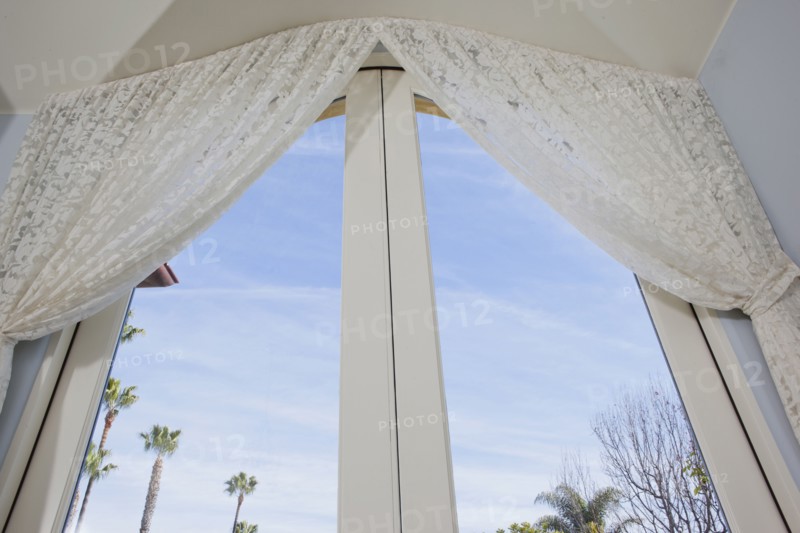 Low angle view of curtain on glass door at home