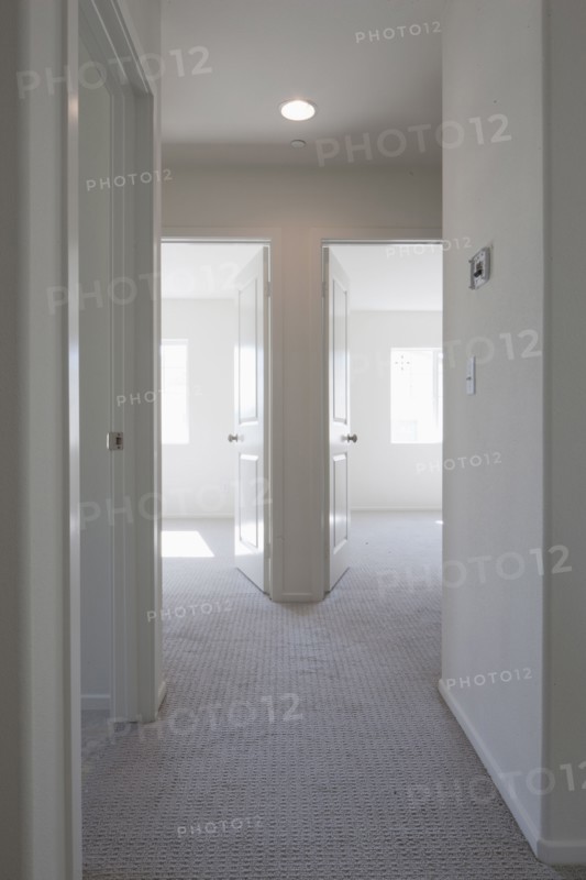 Empty room with open doors and hallway at home