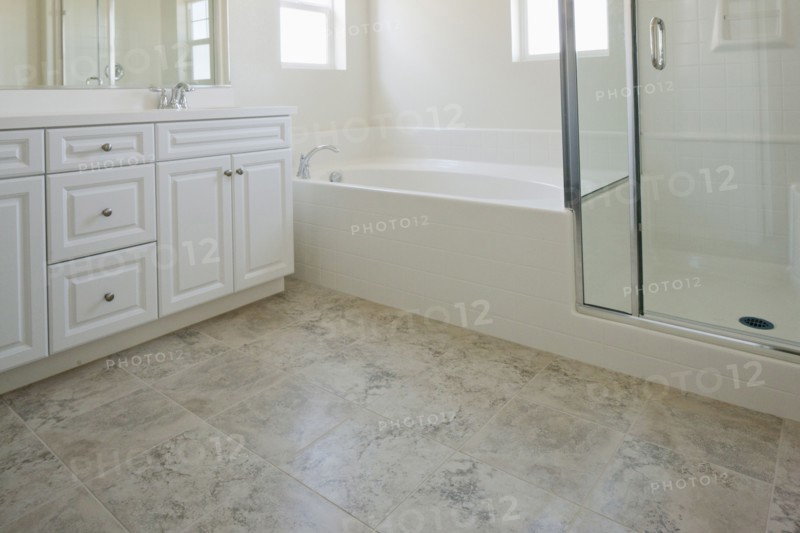 Bathroom with bath and cabinets at home
