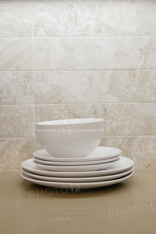 Close-up of bowls with plates in the shelf