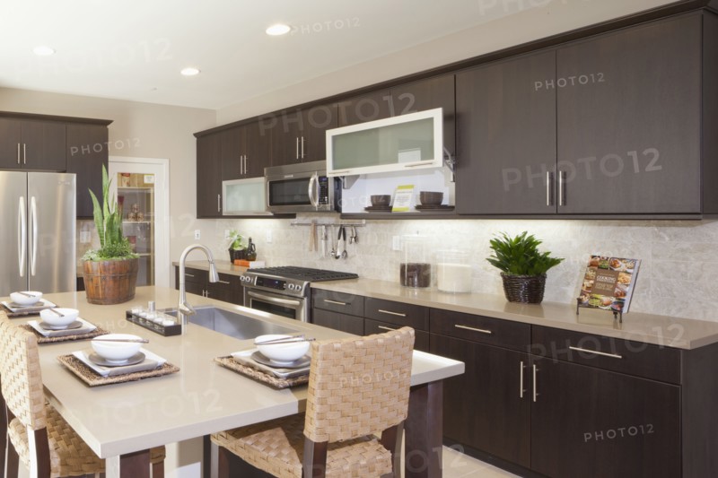 Kitchen having brown cabinets and island at home