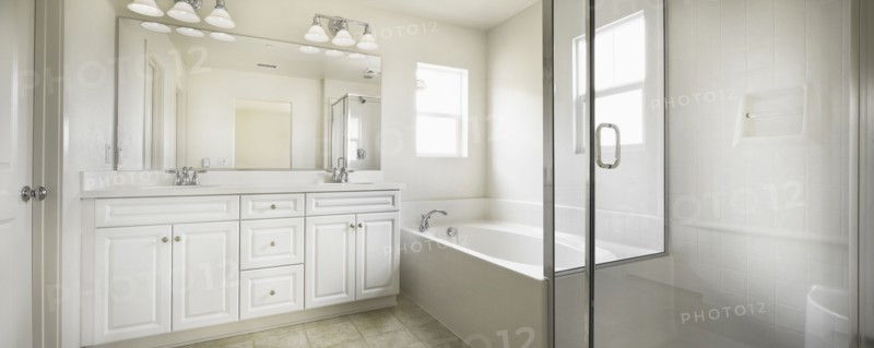 Bathroom with bath and cabinets at home