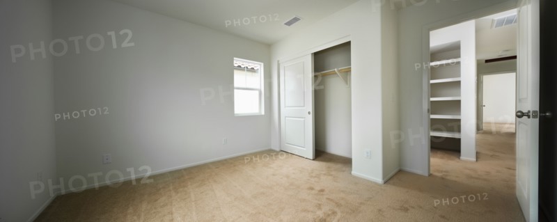 Empty room with open closet door and hallway at home