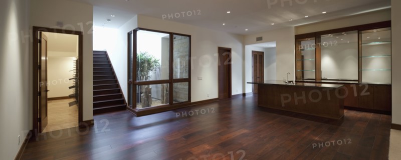 Empty house with kitchen area and wooden floor