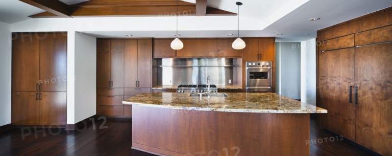 Kitchen having brown cabinets and island at home