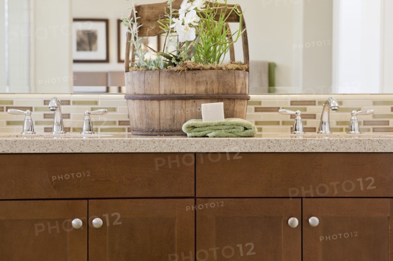 Close-up of taps with brown cabinets at home