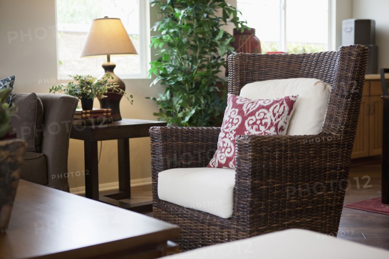 Cushion on wicker armchair in living room