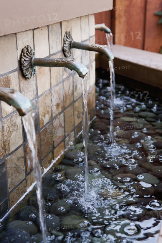 Water flowing from fountains outside house