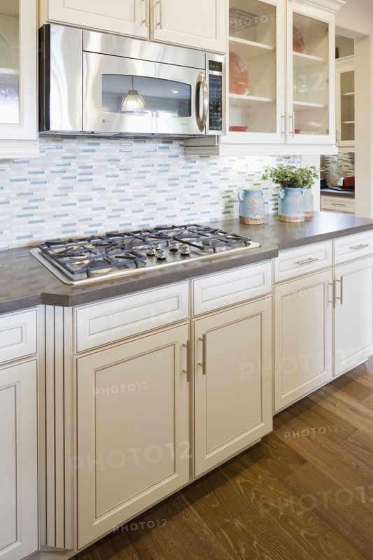Microwave and gas stove in domestic kitchen