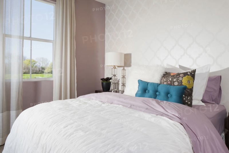 Throw pillows arranged on bed in average house