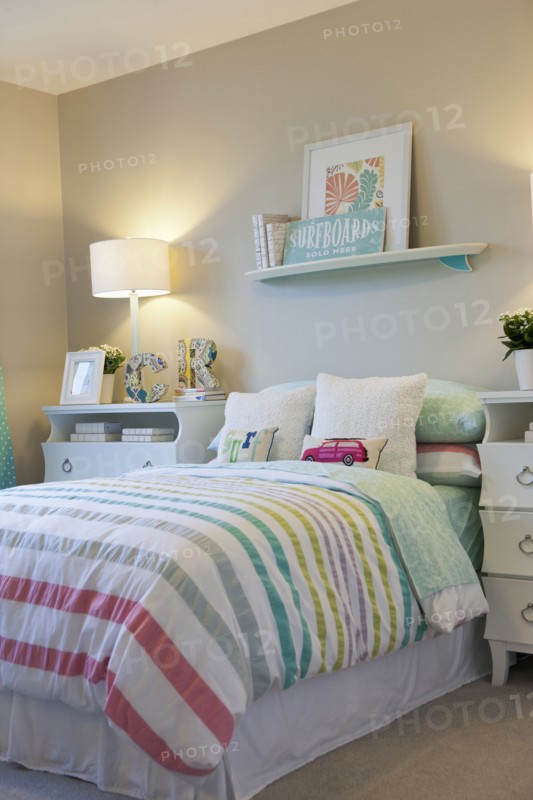 Bed and wall shelf in child's bedroom