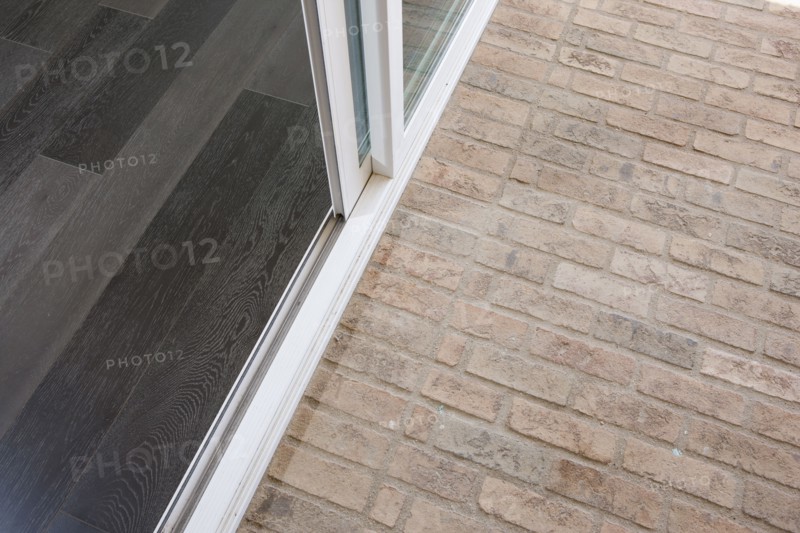 High angle view of stone flooring and sliding door at porch
