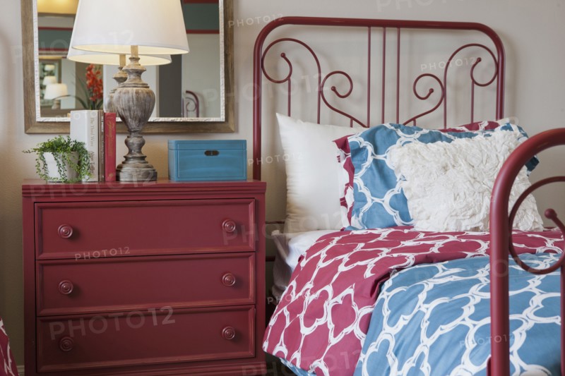 Night table and wrought bed in middle class bedroom