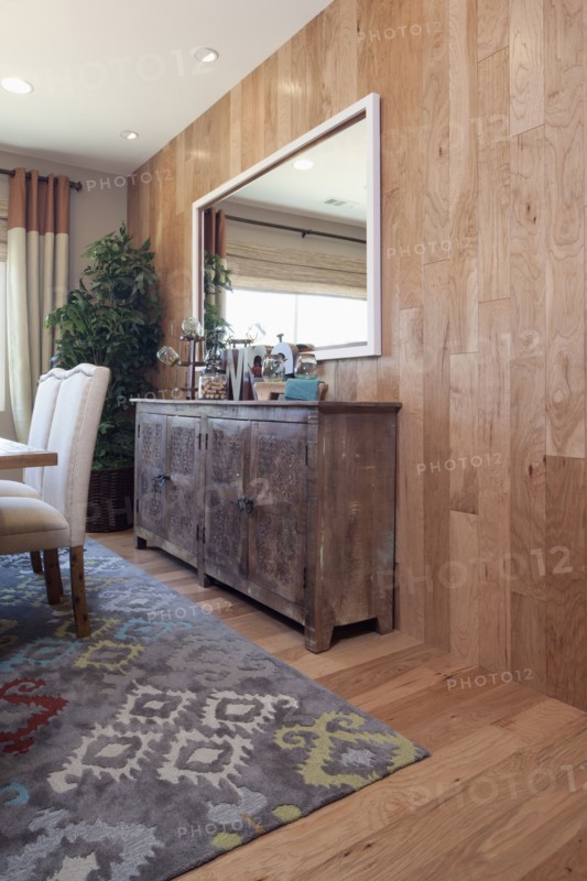 Sideboard with mirror mounted on wooden wall