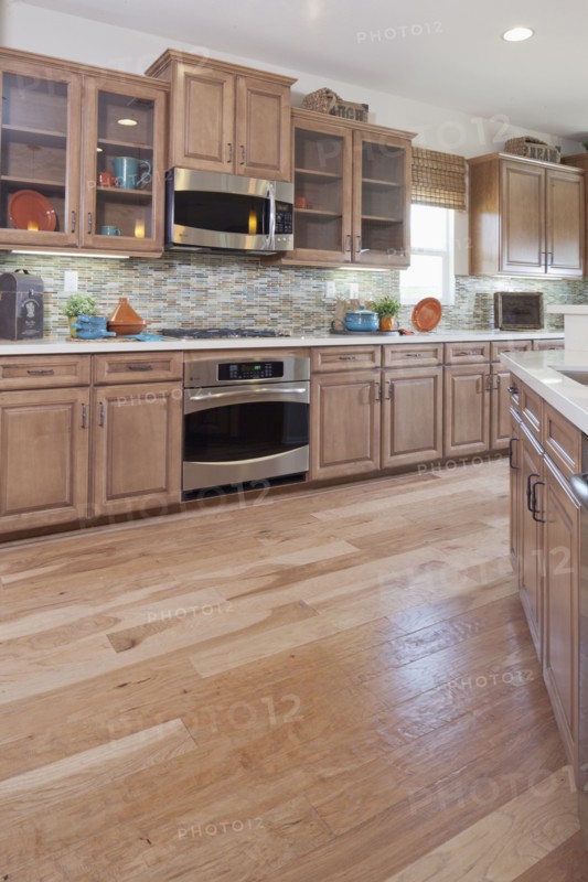 Hardwood floor and wooden cabinets in kitchen