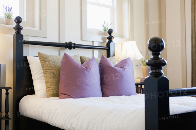 Cushions arranged on bed