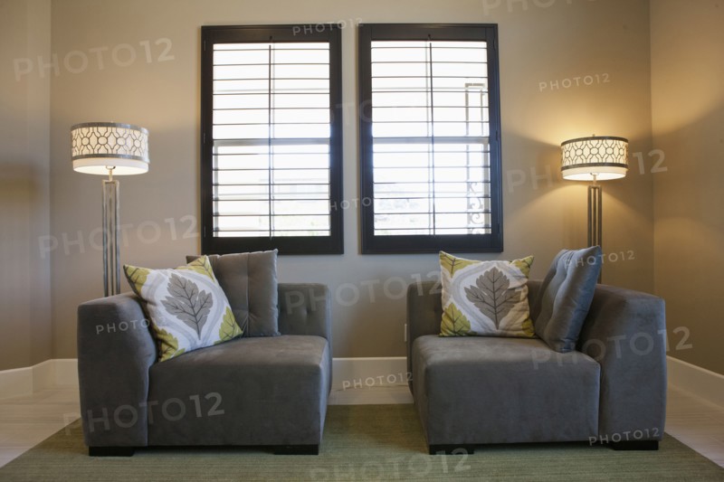 Floor lamps with sitting furniture against window
