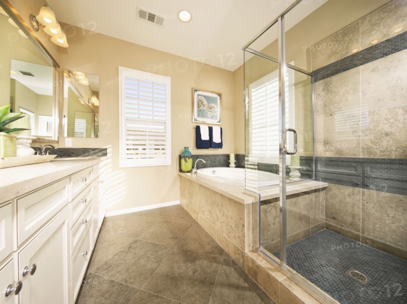 Bathtub and glass shower in bathroom