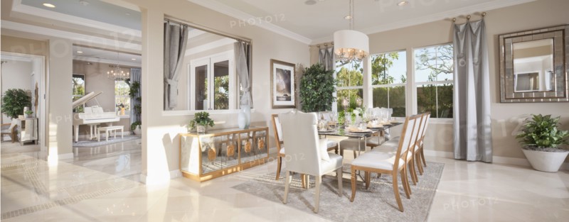 Dining room with piano in the background at a spacious house