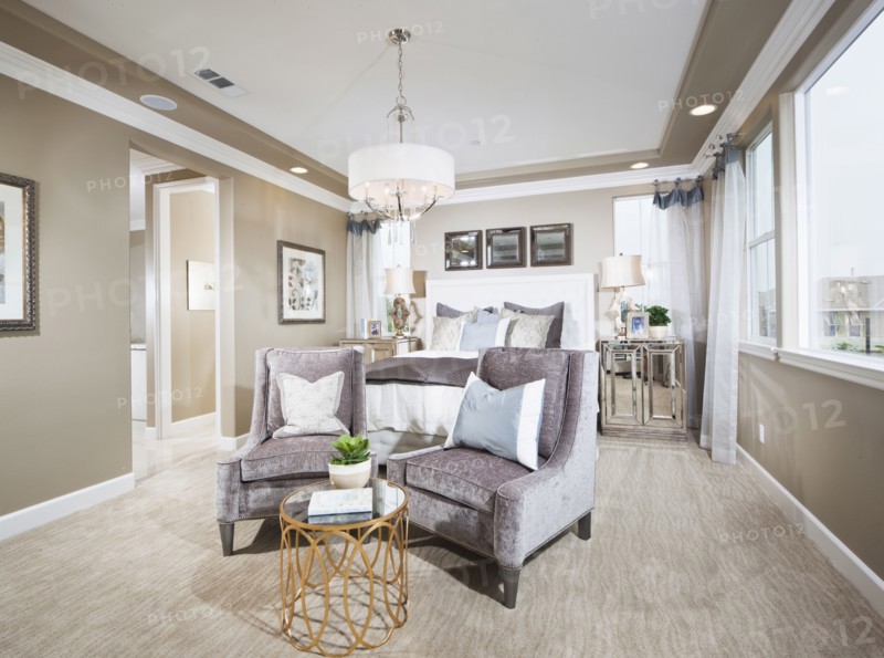 Spacious bedroom with sitting area in foreground at home