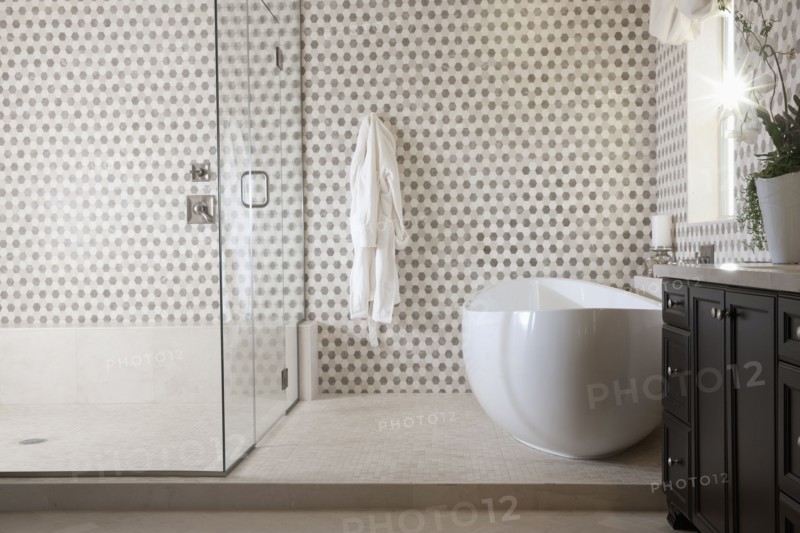 Contemporary bathroom with cropped bath and glass shower at home
