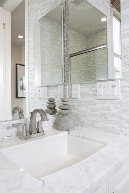 Contemporary bathroom with marble washbasin and mirror at home