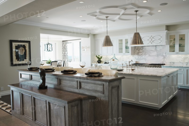 Place settings at breakfast bar in contemporary kitchen