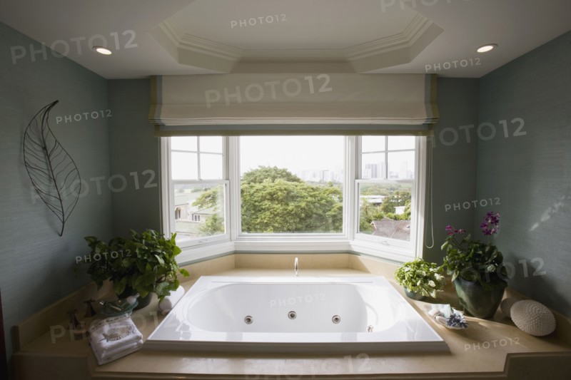 Large hot tub bathtub near window