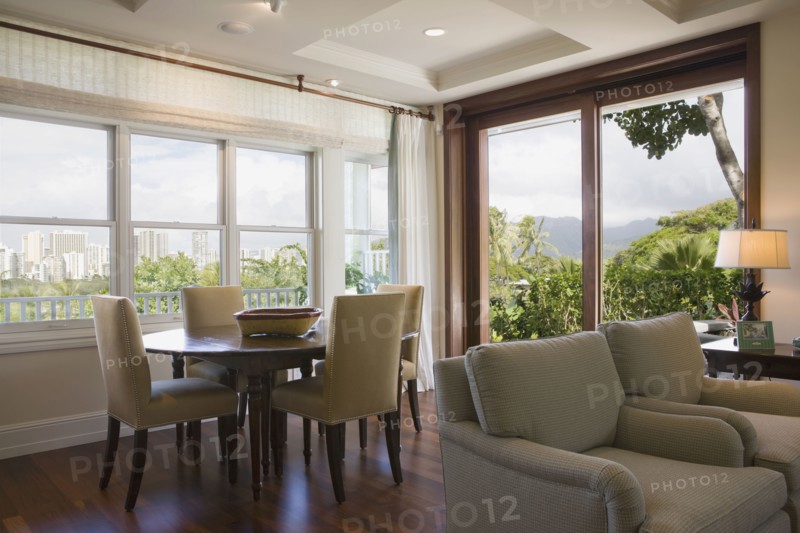 Sitting and dining area in home with downtown Hawaii city view