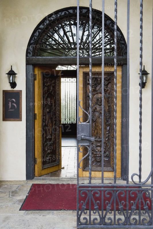 Wrought iron gate and hand carved wooden door