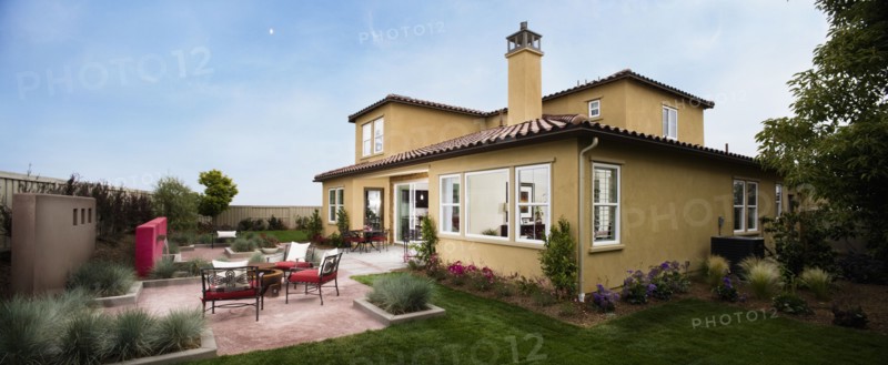 Contemporary patio behind Spanish style home