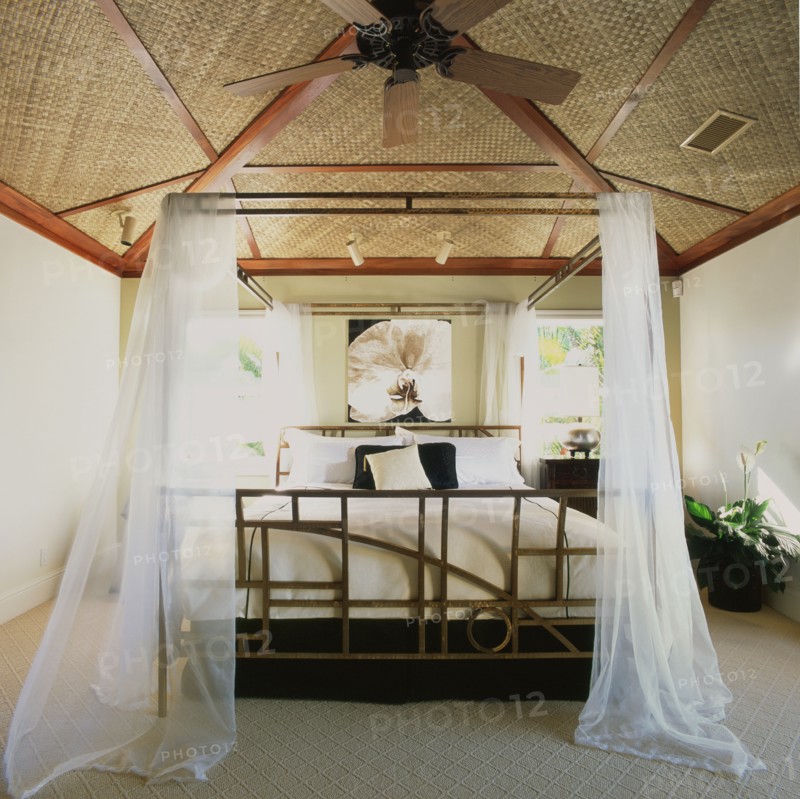 Hawaiian bedroom with mosquito netting around bed