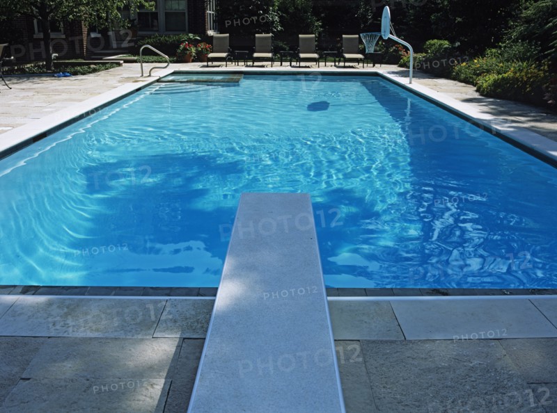 Straight on view looking from over the diving board toward the four lounge chairs