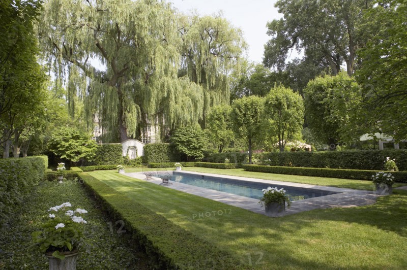 Formal shaped hedge garden with narrow pool