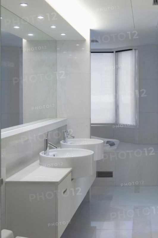 Double bowl sinks in white bathroom