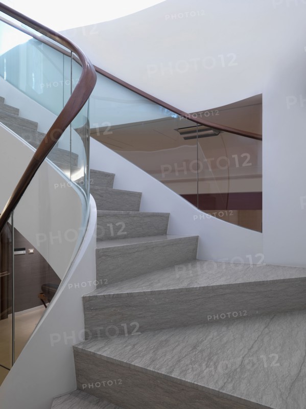 View midway up modern staircase with glass railing