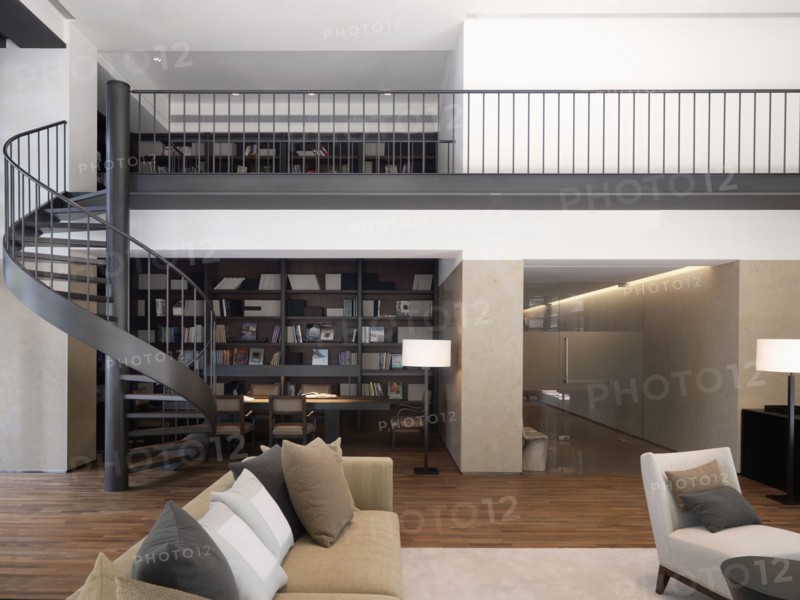 Spiral staircase connecting first and second stories of modern home