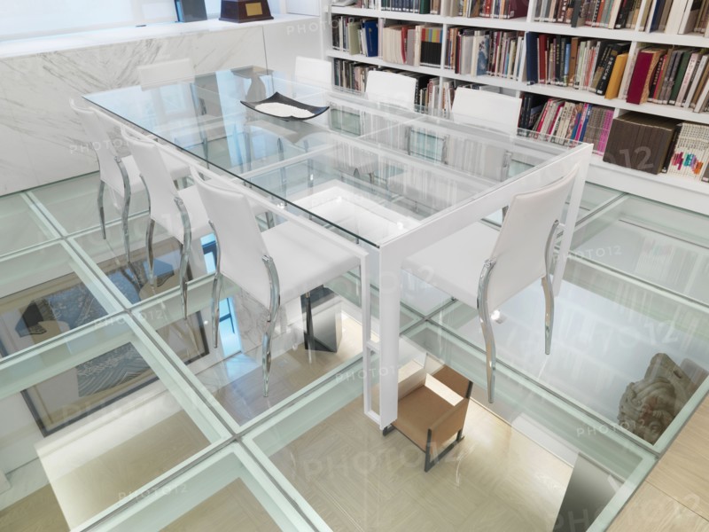 Glass conference table in room with glass floor