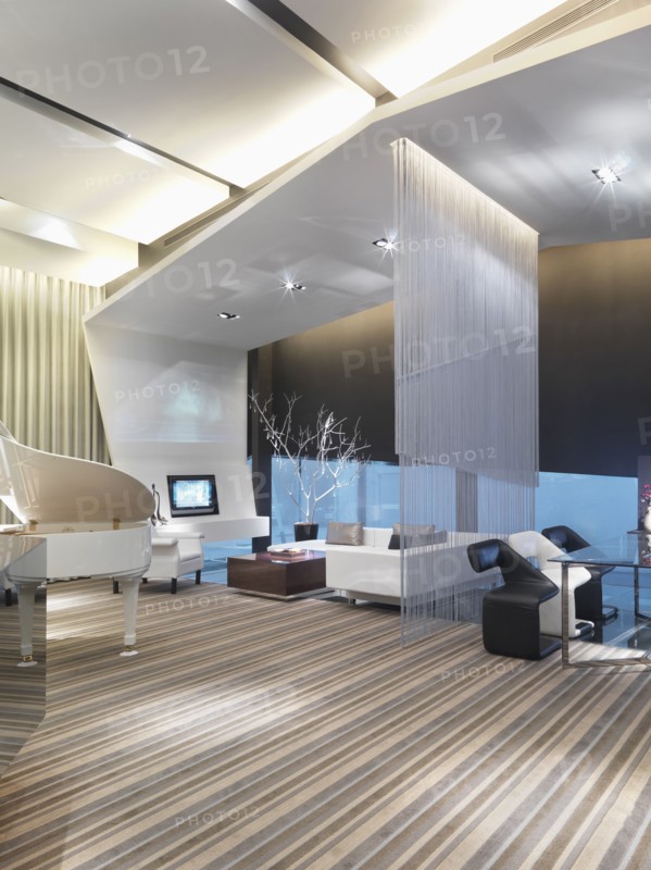 Modern living and dining room separated by string curtain