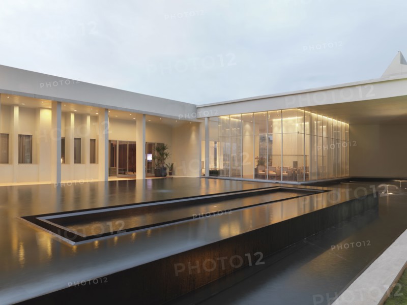 Large infinity pool out front of modern home