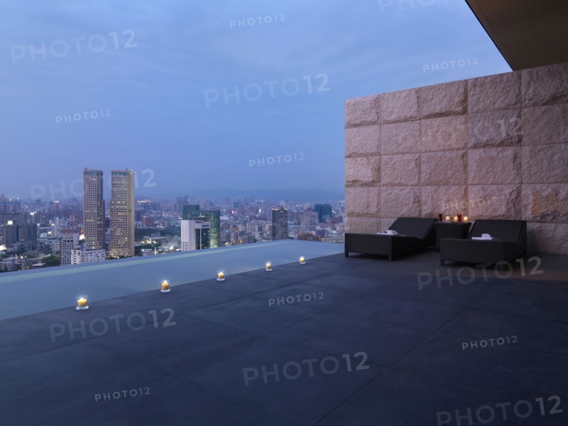Two lounge chairs on outdoor terrace above city
