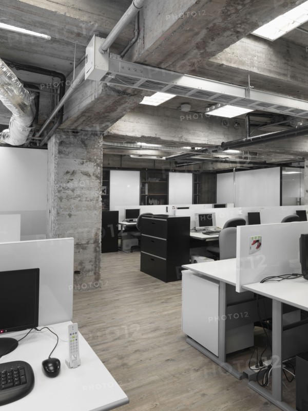Modern industrial office with rows of computers