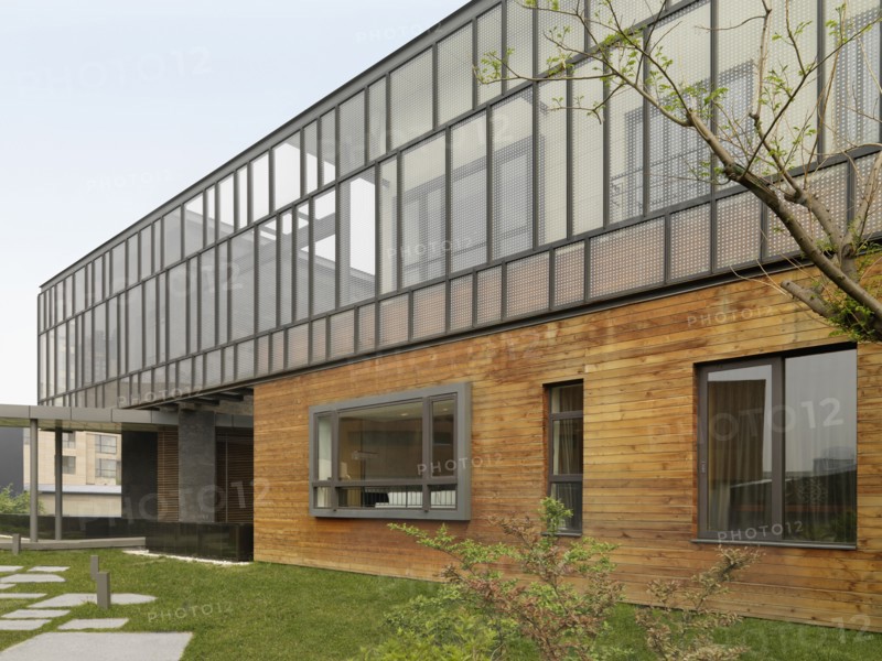 Exterior view multiple story modern home with hardwood siding