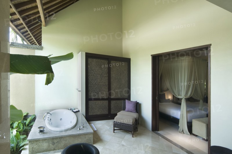 Bathroom with hot tub open to outside