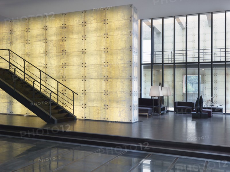 Modern staircase in front of illuminated wall