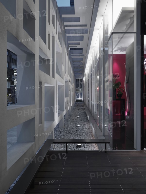Landscape lighting in stones along modern building