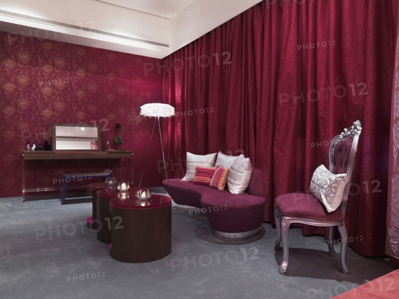 Chic bedroom with pink glass coffee table and grey carpet