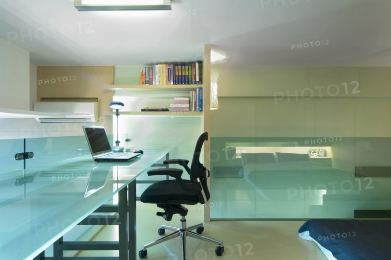 Desk and office chair in bedroom of modern home