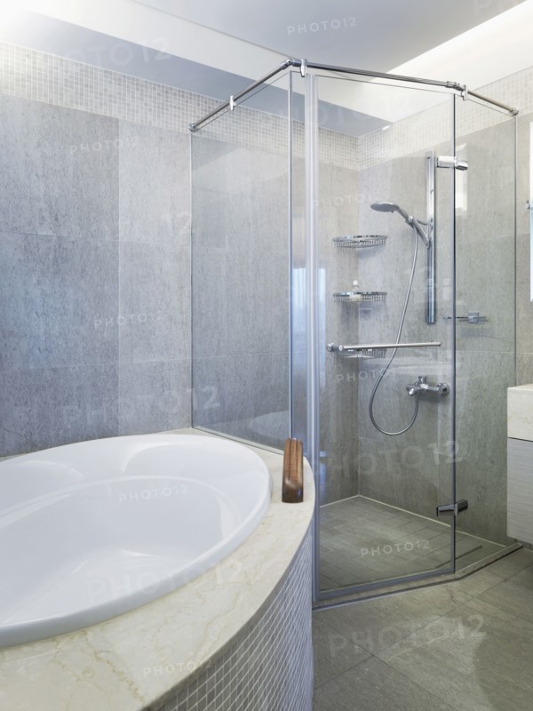 Bathtub and glass shower in modern bathroom